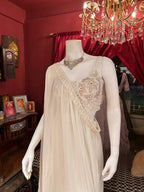 Sober white spaghetti-strap crop choli with asymmetrical shrug.